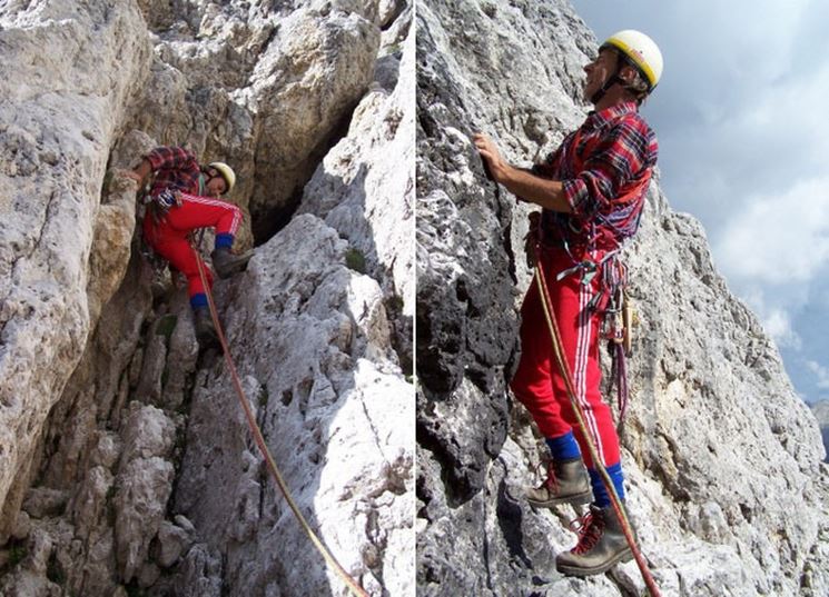 Alpinista durante una scalata su una parete rocciosa